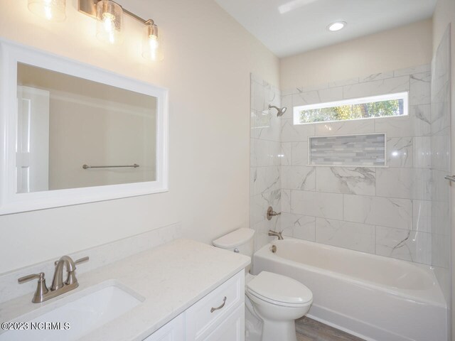 bathroom with toilet and tiled shower / bath combo