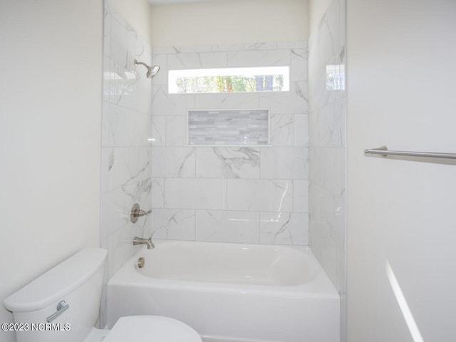 bathroom featuring toilet and  shower combination