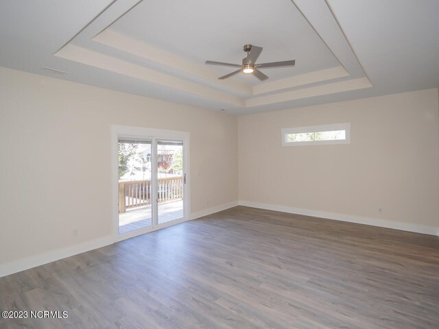 bathroom with toilet, hardwood / wood-style floors, walk in shower, and vanity