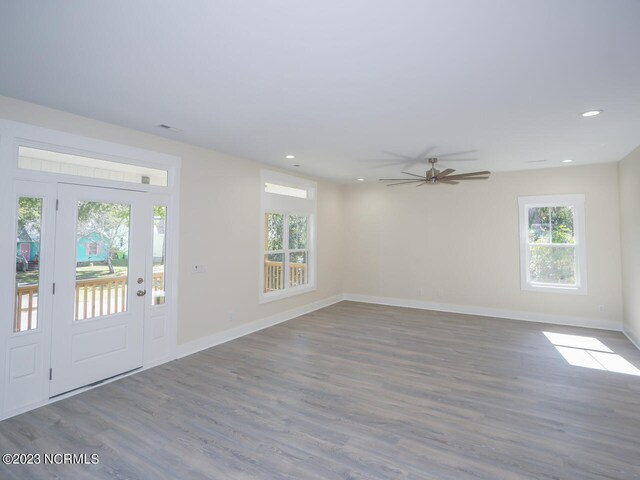 interior space with light hardwood / wood-style floors, a center island, decorative backsplash, white cabinetry, and stainless steel fridge with ice dispenser