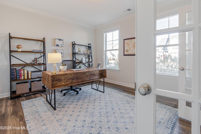 home office with dark hardwood / wood-style floors and crown molding