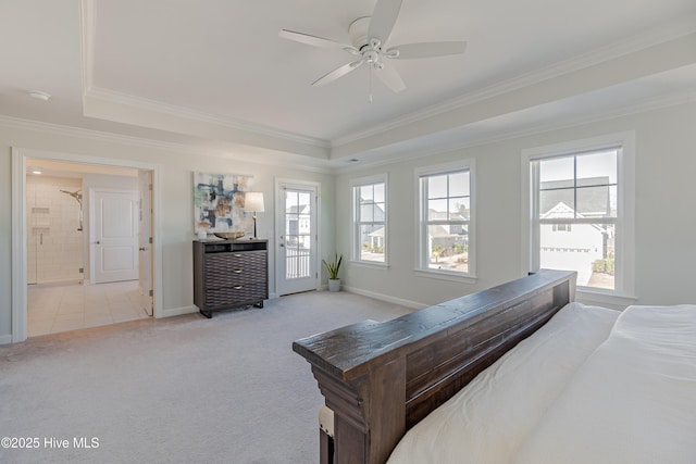 carpeted bedroom featuring ceiling fan, ornamental molding, and a tray ceiling