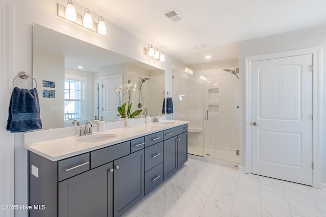 bathroom featuring an enclosed shower and vanity