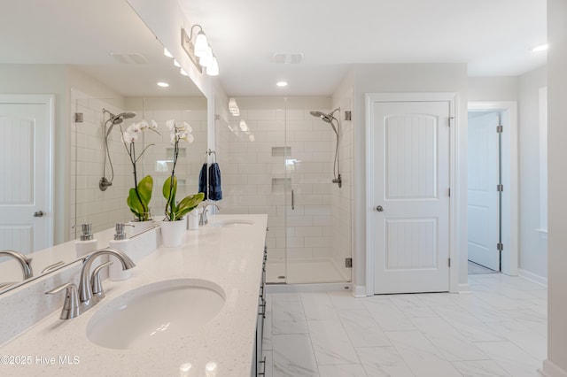 bathroom with walk in shower and vanity