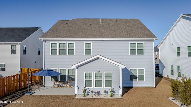 back of property with a patio and a lawn