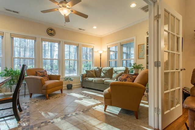 sunroom featuring ceiling fan and french doors