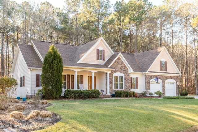 view of front of home with a garage, a front yard, and covered porch