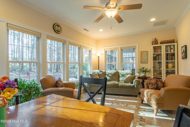 sunroom with a healthy amount of sunlight and ceiling fan