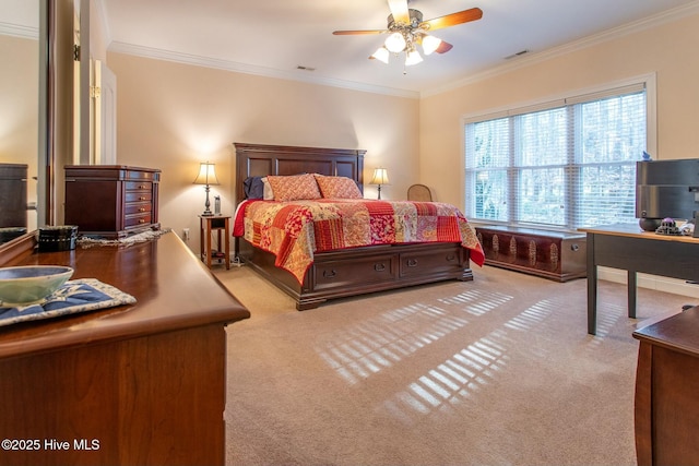 carpeted bedroom featuring crown molding and ceiling fan