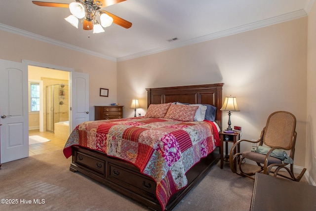 bedroom featuring crown molding, light colored carpet, ceiling fan, and ensuite bath