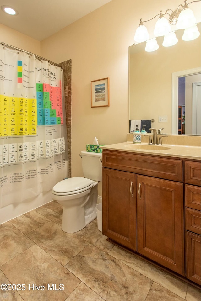 bathroom featuring walk in shower, vanity, toilet, and tile patterned flooring