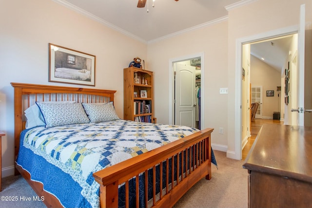 bedroom with ornamental molding, light colored carpet, and ceiling fan