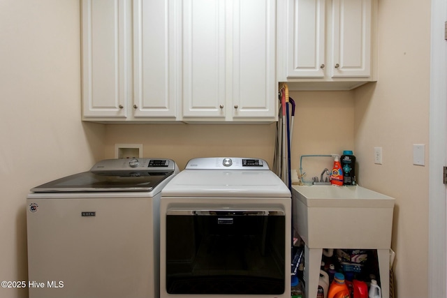 laundry area with cabinets, sink, and independent washer and dryer