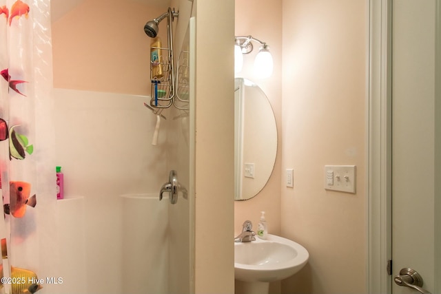 bathroom featuring sink and a shower with curtain