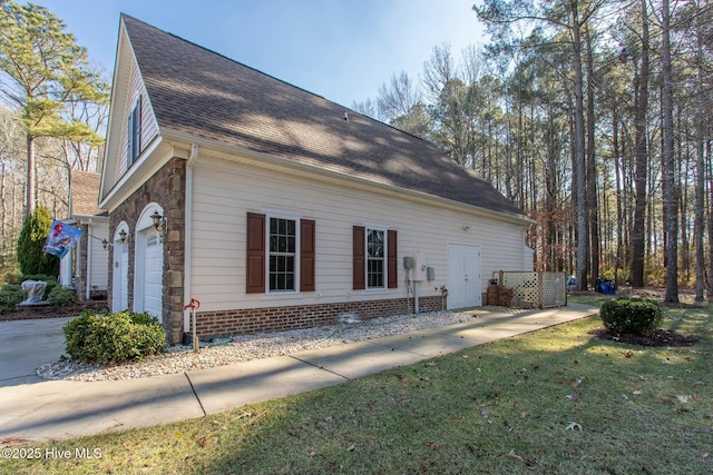 view of property exterior featuring a yard and a garage