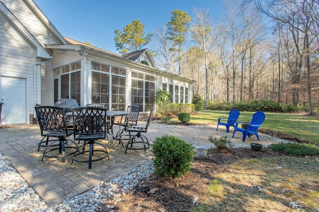 view of patio featuring a sunroom