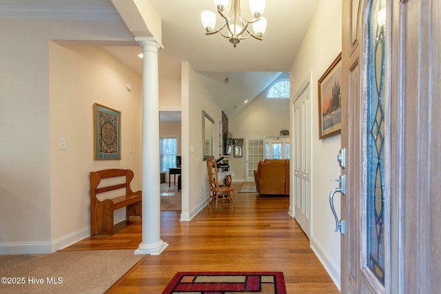 entrance foyer featuring hardwood / wood-style flooring, plenty of natural light, and ornate columns