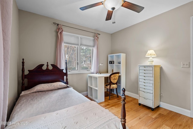 bedroom with baseboards, ceiling fan, and light wood finished floors