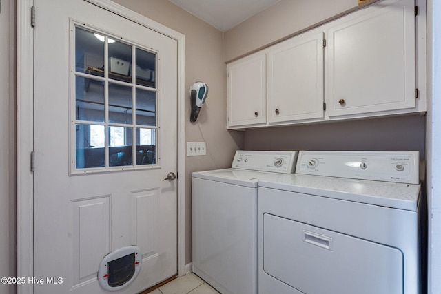 laundry area featuring cabinet space, light tile patterned floors, and separate washer and dryer