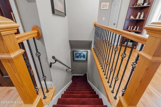 stairs with baseboards and wood finished floors