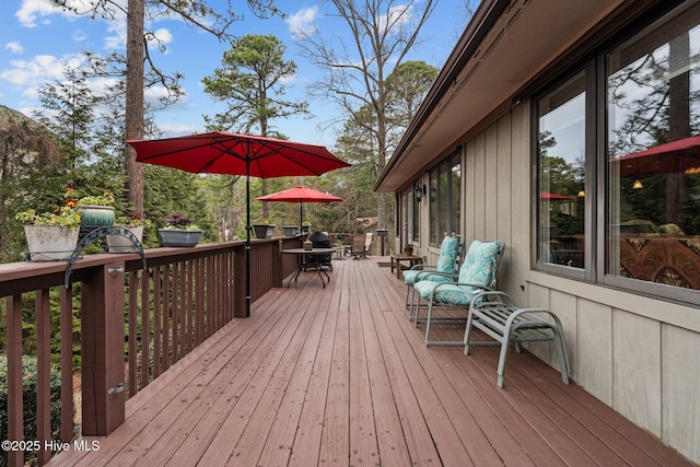 wooden terrace featuring outdoor dining area