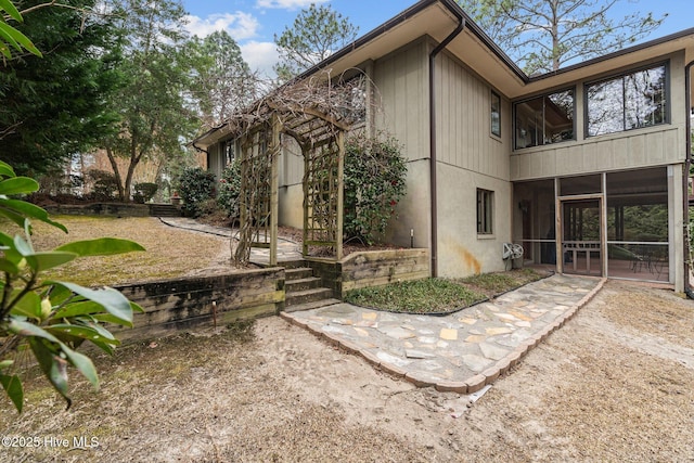 view of side of home featuring a sunroom