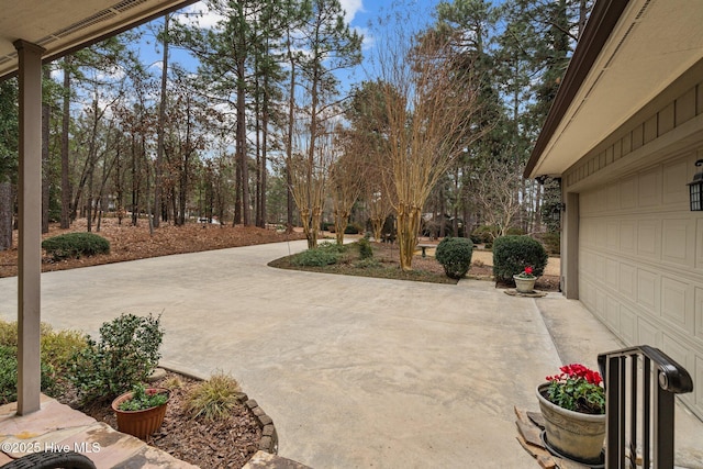 view of patio / terrace featuring a garage and driveway