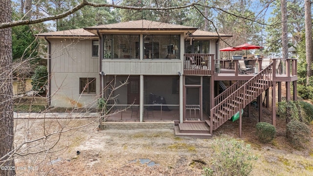 back of house with stairs, a patio area, a wooden deck, and a sunroom