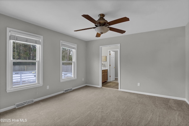 carpeted spare room with ceiling fan