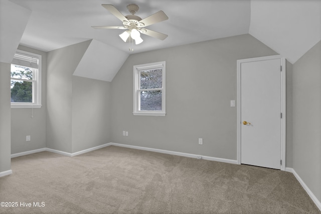 additional living space with ceiling fan, vaulted ceiling, and light carpet