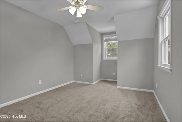 bonus room with ceiling fan, light colored carpet, and vaulted ceiling