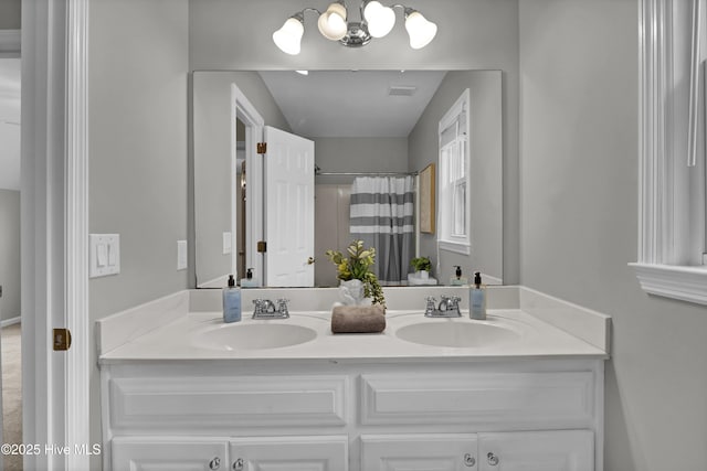 bathroom featuring vanity, a notable chandelier, and a shower with shower curtain