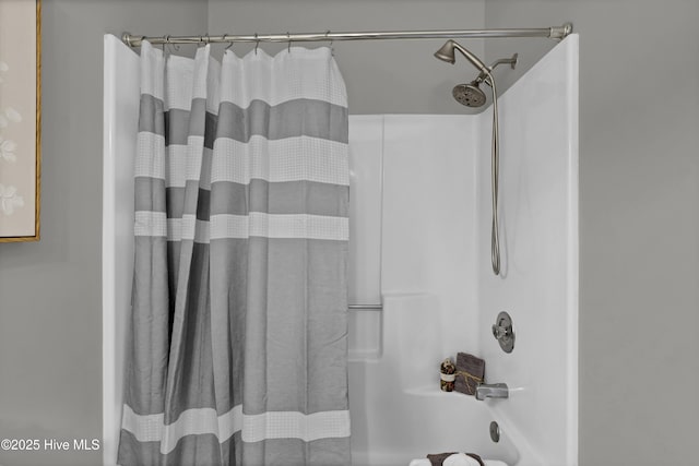 bathroom with shower / tub combo with curtain