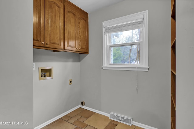 laundry room with light tile patterned flooring, cabinets, hookup for an electric dryer, and hookup for a washing machine