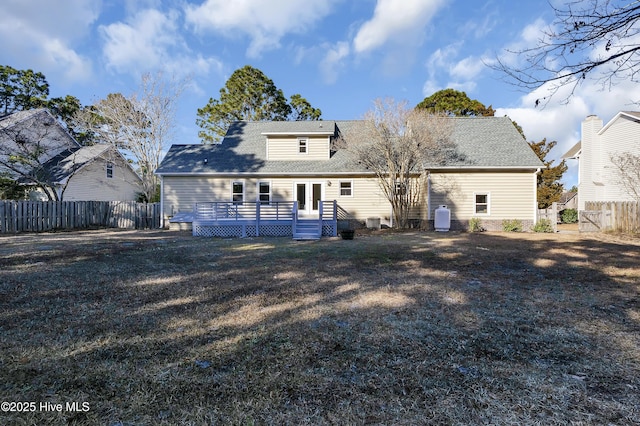 back of property with a wooden deck, central AC, and a lawn