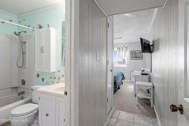 full bathroom with shower / bathing tub combination, tile patterned flooring, vanity, toilet, and crown molding