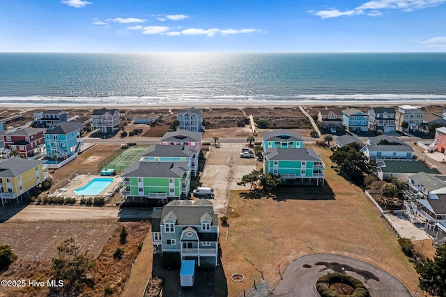 drone / aerial view featuring a water view and a beach view