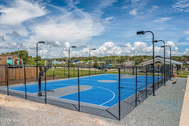 view of basketball court with a playground