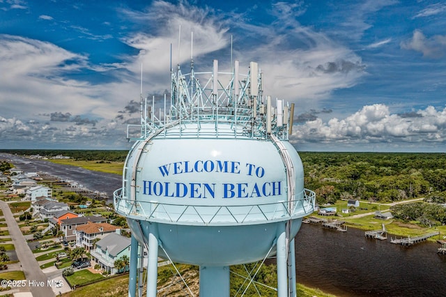 community / neighborhood sign with a water view