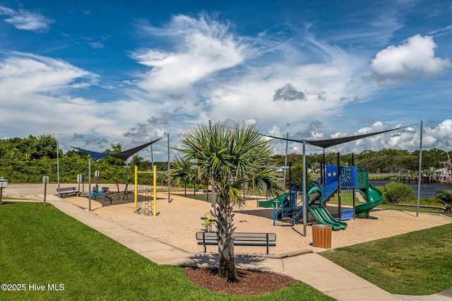 view of playground with a water view and a yard