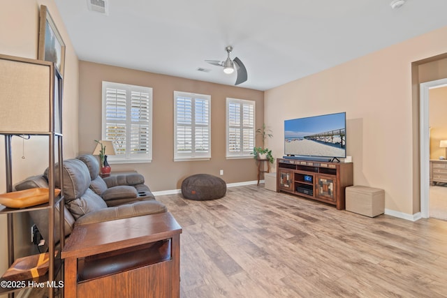 living room with light wood-type flooring and ceiling fan