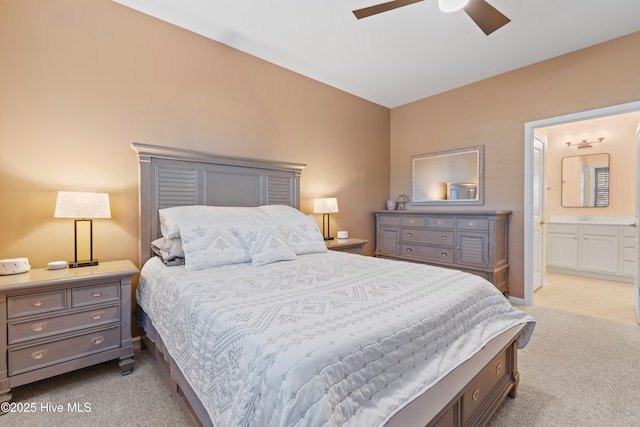 carpeted bedroom with ceiling fan and ensuite bathroom