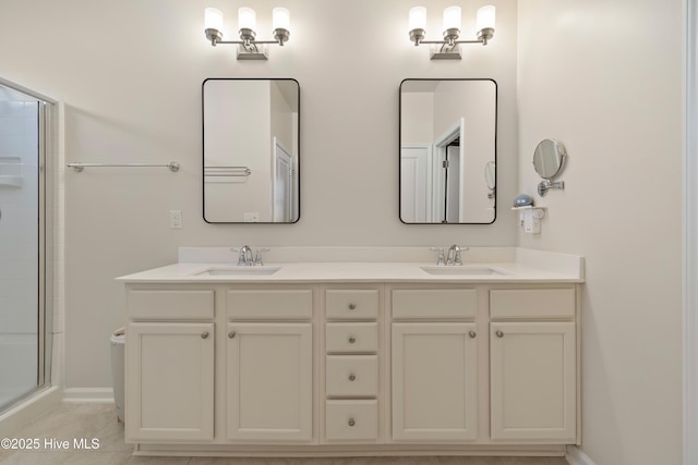 bathroom with tile patterned flooring, a shower with door, and vanity