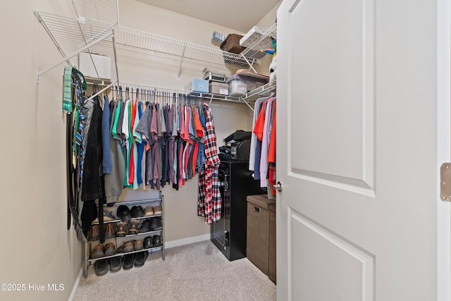 walk in closet featuring carpet flooring