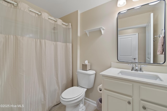 bathroom featuring toilet, vanity, and a shower with curtain