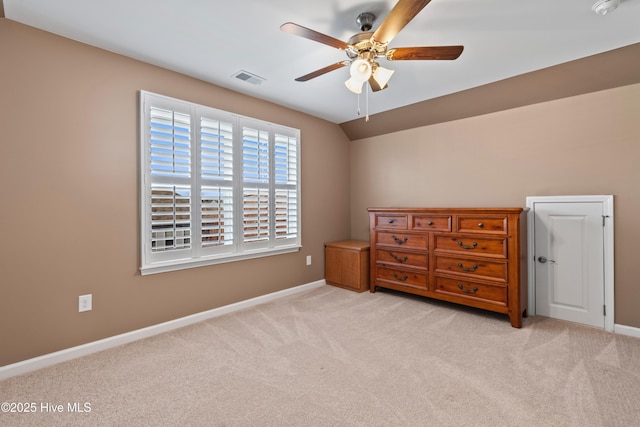 bedroom with ceiling fan, light colored carpet, and lofted ceiling