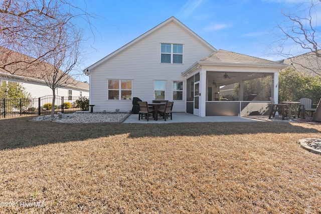 back of house featuring ceiling fan, a sunroom, a yard, and a patio