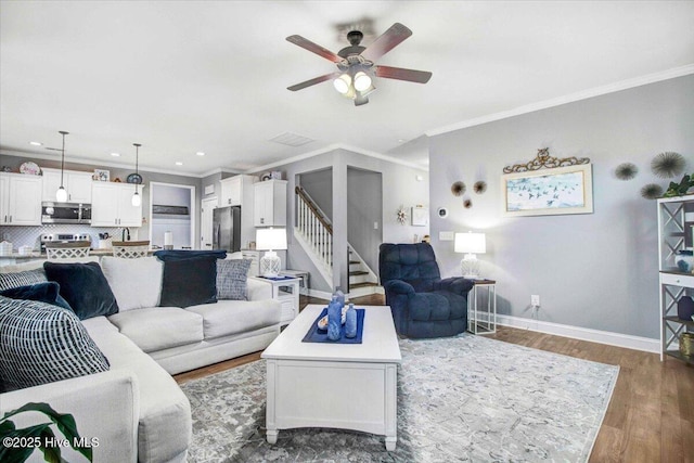 living room featuring ceiling fan, dark wood-type flooring, and ornamental molding