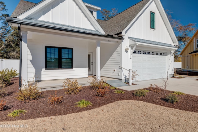 view of front of house with covered porch and a garage