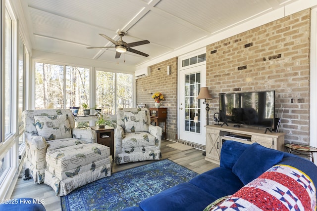 sunroom with ceiling fan and a wall unit AC